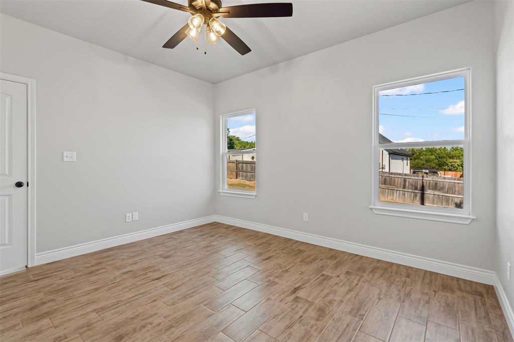 3400 Hilltop Road Granbury, TX 76048 - Photo 30 of 40 a view of an empty room with wooden floor and a window