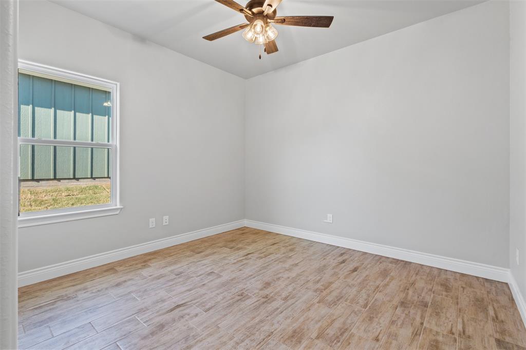 3400 Hilltop Road Granbury, TX 76048 - Photo 33 of 40 an empty room with a window and a ceiling fan