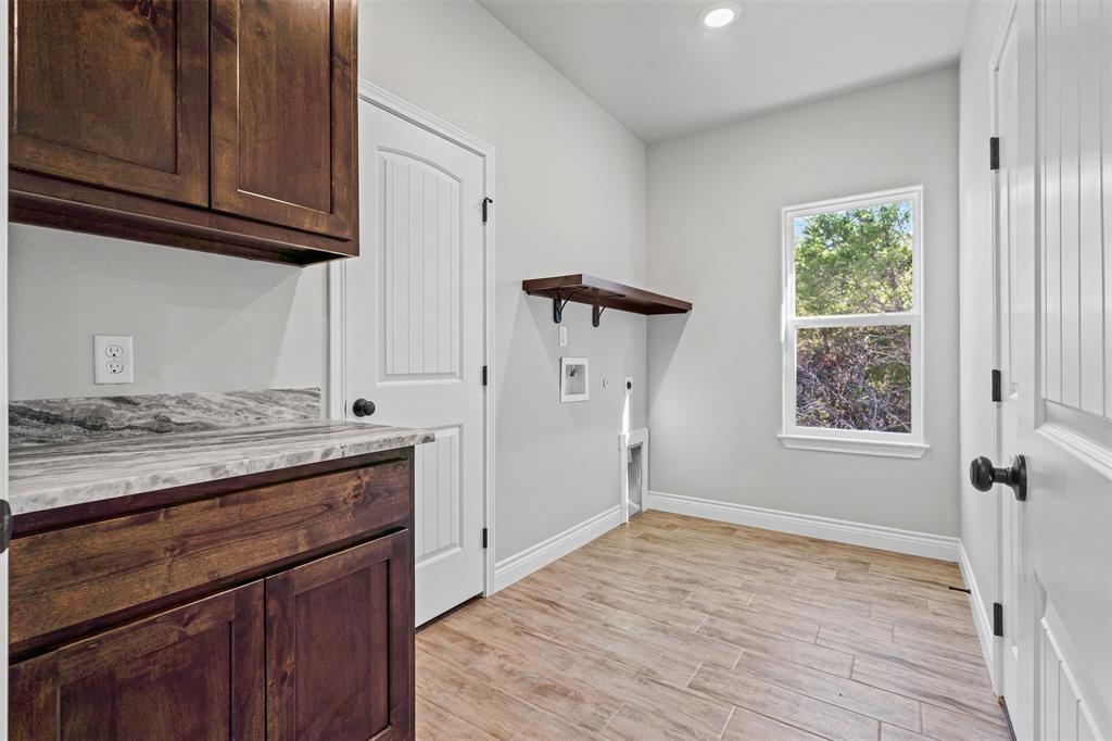 3400 Hilltop Road Granbury, TX 76048 - Photo 34 of 40 a view of a kitchen with a sink cabinets and wooden floor