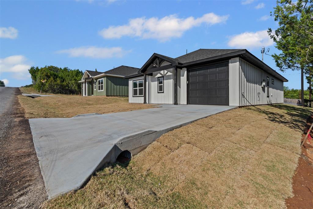 3400 Hilltop Road Granbury, TX 76048 - Photo 4 of 40 a front view of a house with a yard