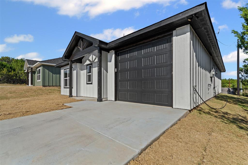 3400 Hilltop Road Granbury, TX 76048 - Photo 6 of 40 a front view of a house with a yard