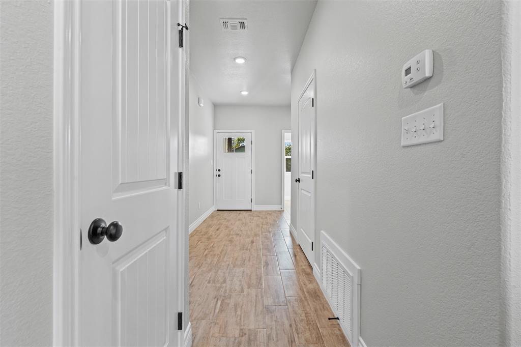3400 Hilltop Road Granbury, TX 76048 - Photo 9 of 40 a view of a hallway with wooden floor