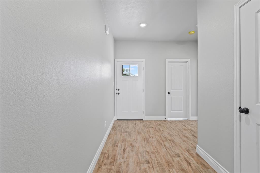 3400 Hilltop Road Granbury, TX 76048 - Photo 10 of 40 a view of a hallway with wooden floor