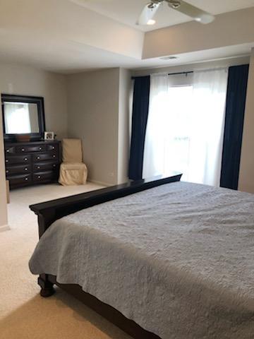 347 Emerald Lane, Unit 347 Algonquin, IL 60102 - Photo 5 of 11 a bedroom with a bed and wooden floor