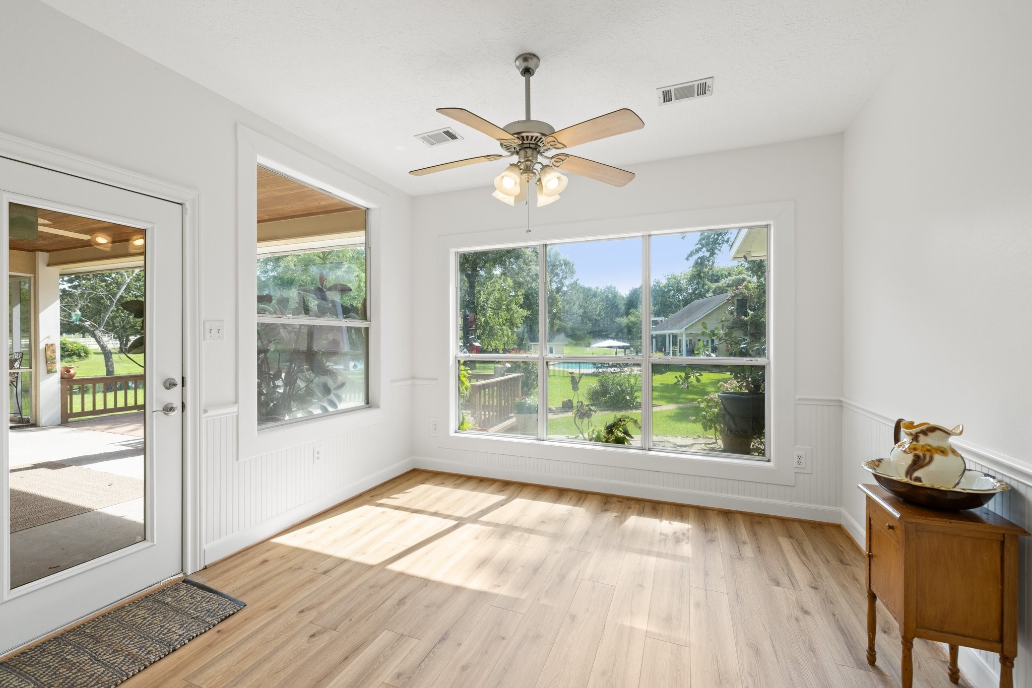 34310 High Point Drive Magnolia, TX 77355 - Photo 12 of 48 Bright and airy breakfast area with large windows, offering beautiful views of the backyard. Features beautiful vinyl plank flooring, a ceiling fan, and access to a covered patio. Perfect for relaxing or entertaining.