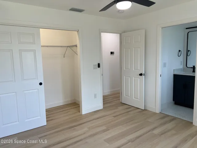 a view of a room with wooden floor and closet