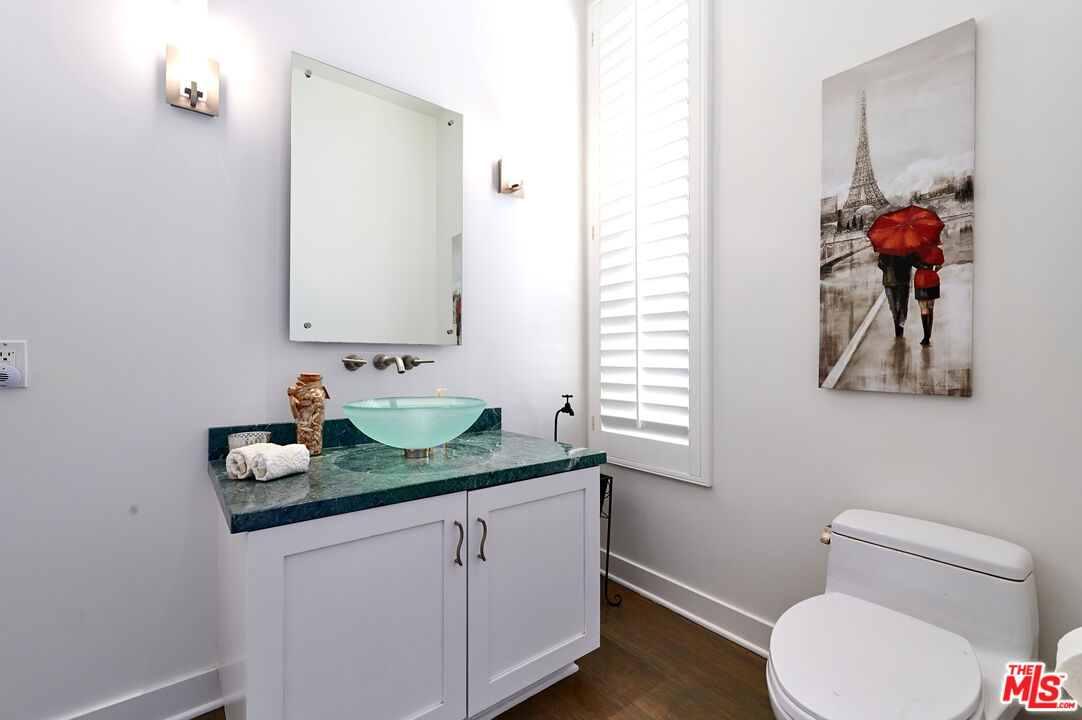28907 Wight Road Malibu, CA 90265 - Photo 29 of 54 a bathroom with a granite countertop sink and a toilet