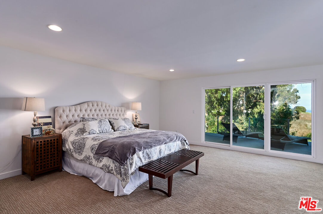 28907 Wight Road Malibu, CA 90265 - Photo 32 of 54 a spacious bedroom with a bed and large window