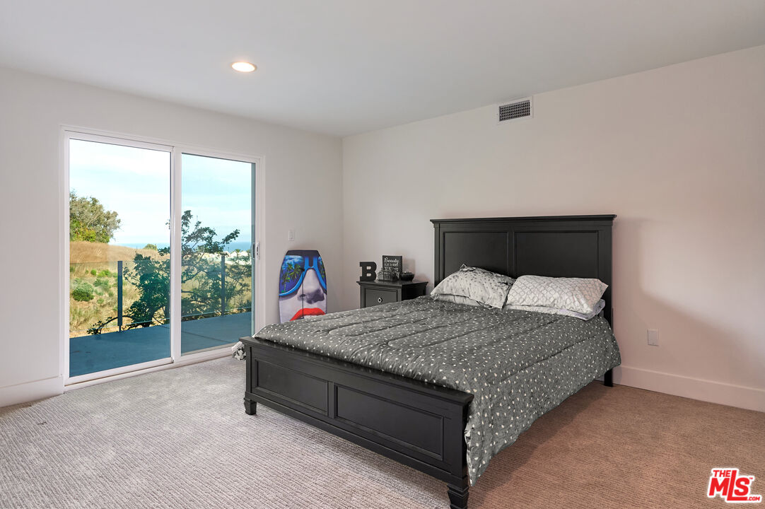 28907 Wight Road Malibu, CA 90265 - Photo 43 of 54 a bed sitting in a bedroom next to a window