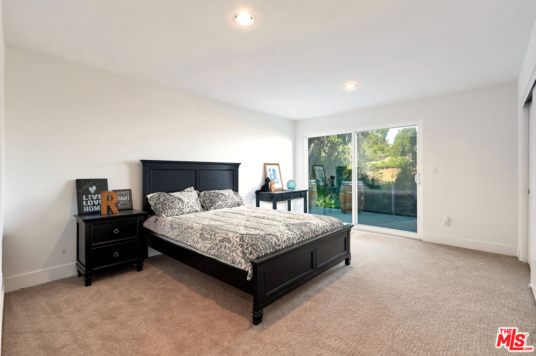 28907 Wight Road Malibu, CA 90265 - Photo 44 of 54 a spacious bedroom with a bed and large window