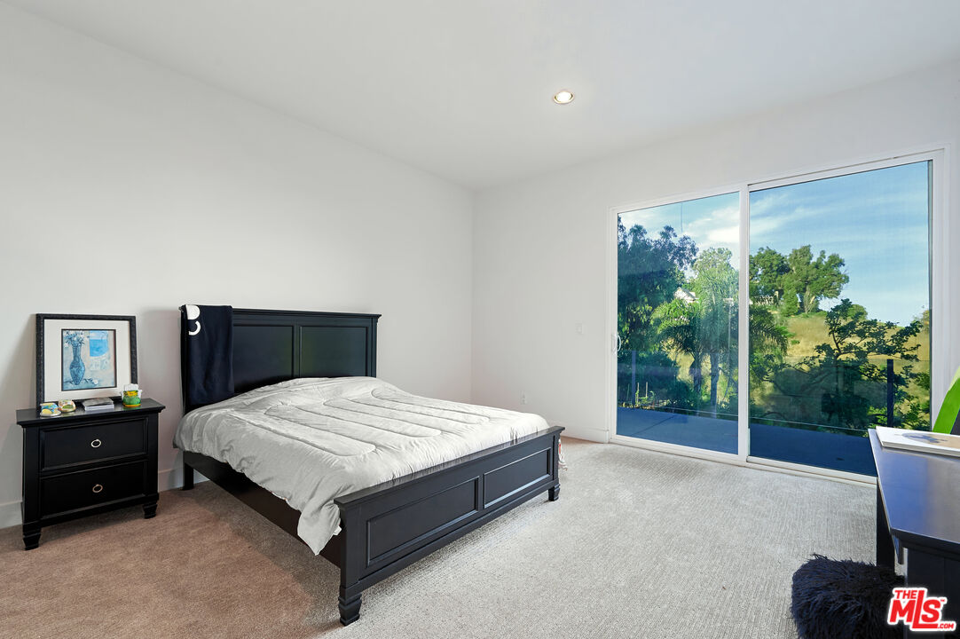 28907 Wight Road Malibu, CA 90265 - Photo 47 of 54 a spacious bedroom with a bed and a window