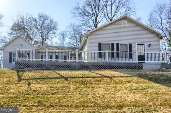 a front view of a house with swimming pool and porch