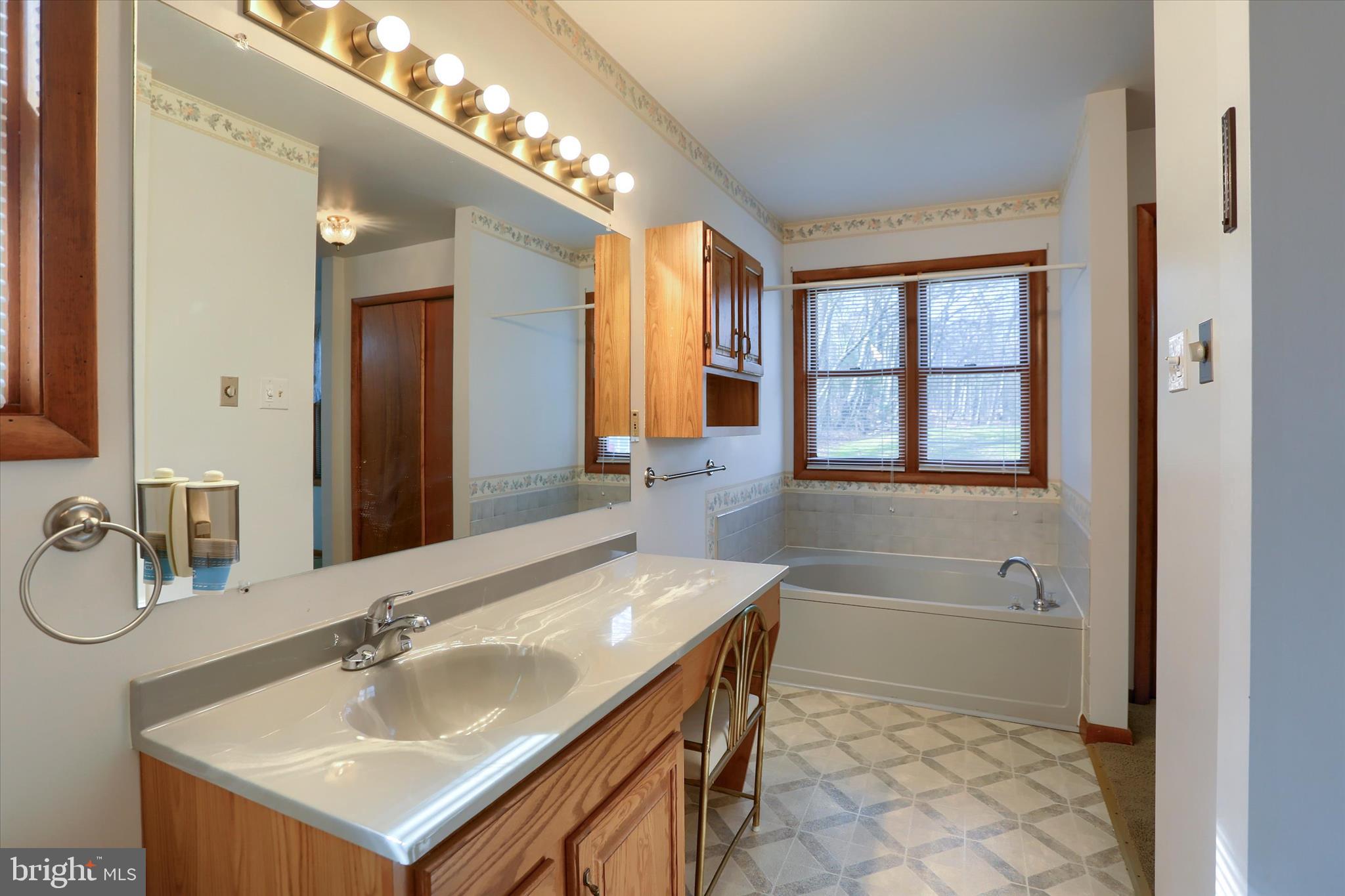 149 Stone Mountain Road Pine Grove, PA 17963 - Photo 34 of 64 a bathroom with a sink double vanity granite tub and a mirror