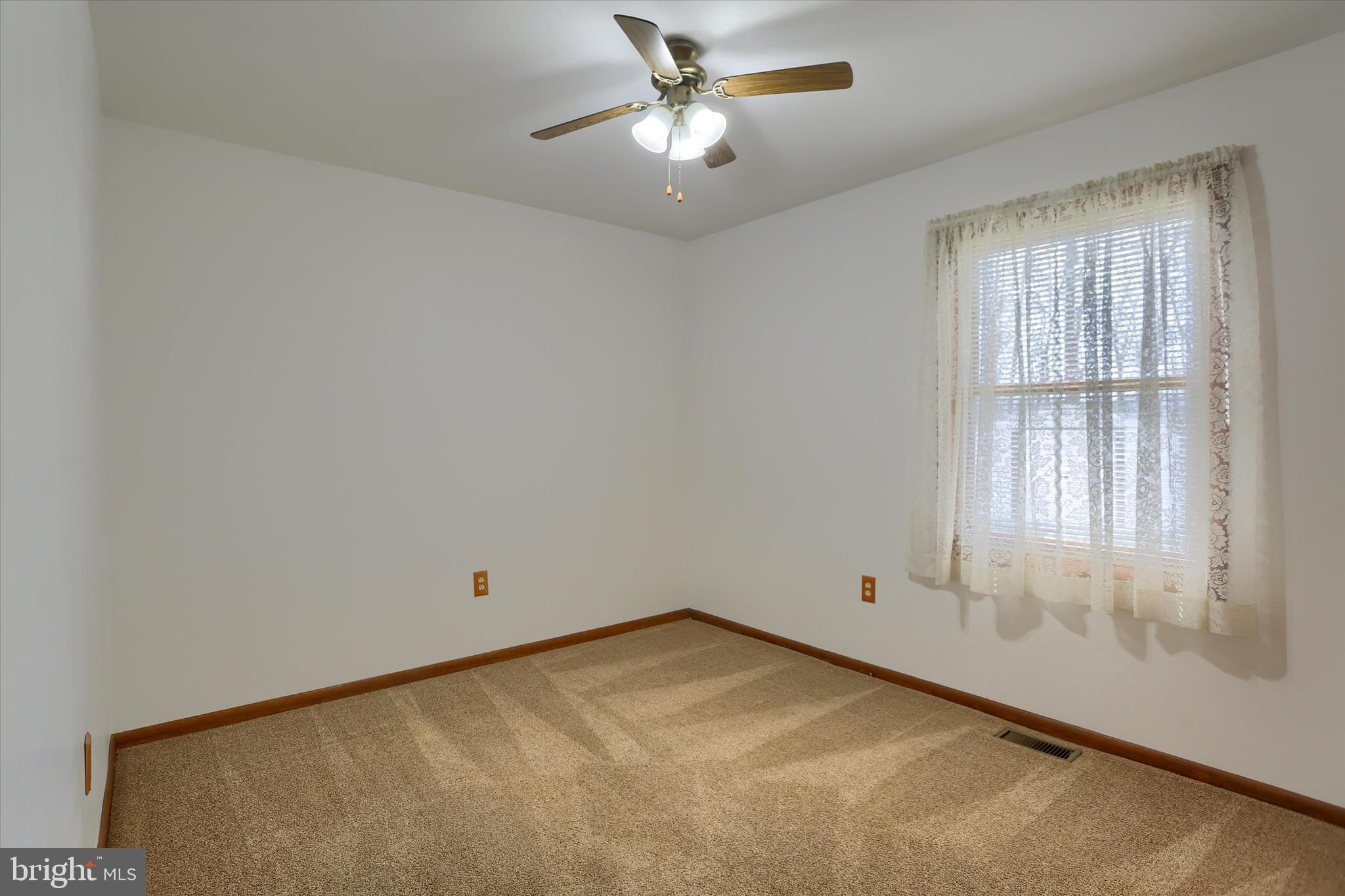 149 Stone Mountain Road Pine Grove, PA 17963 - Photo 36 of 64 an empty room with a window and a ceiling fan