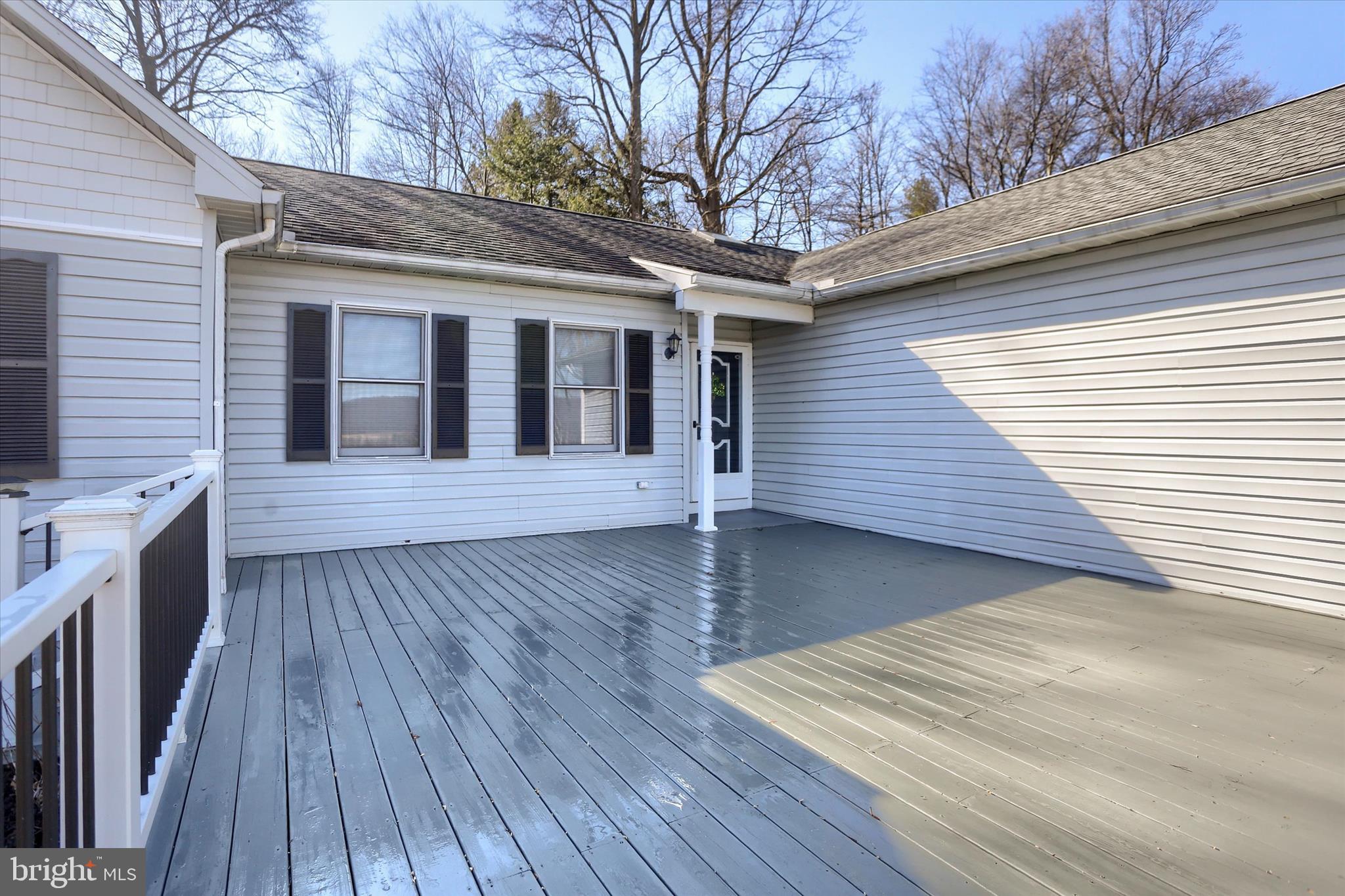 149 Stone Mountain Road Pine Grove, PA 17963 - Photo 9 of 64 a view of a deck with wooden floor and fence next to a yard