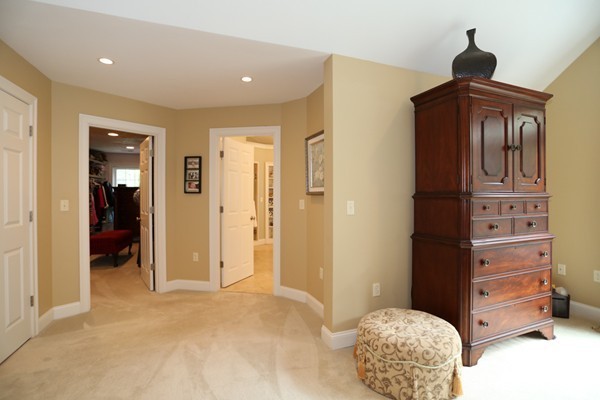 4 Marked Tree Road Sudbury, MA 01776 - Photo 17 of 27 a bedroom with a dresser and a chandelier