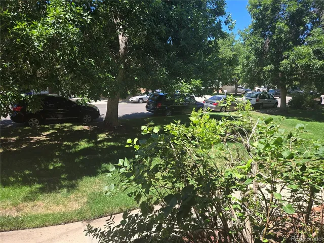 a backyard of a house with lots of green space and outdoor seating