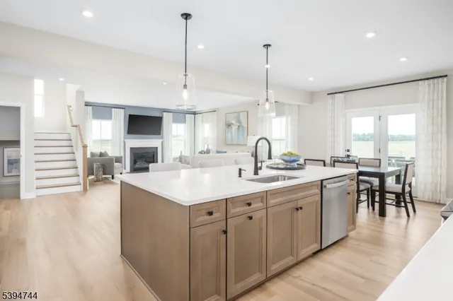 a kitchen with counter top space sink stove and wooden floor