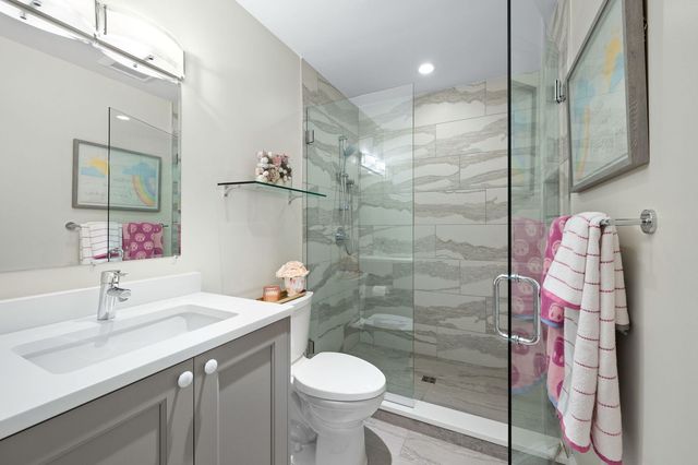 a bathroom with a sink toilet and shower