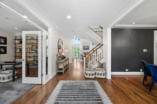 a view of a hallway with wooden floor and windows