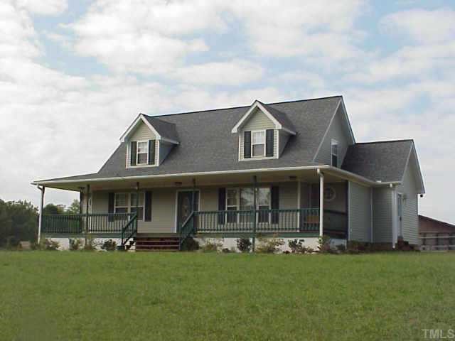86 Sam Brummitt Road Henderson, NC 27537 - Photo 1 of 1 a front view of a house with a garden