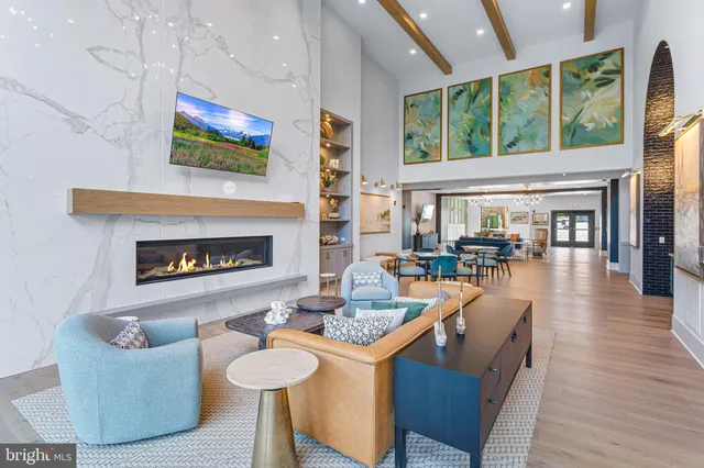 a living room with fireplace furniture and a large window