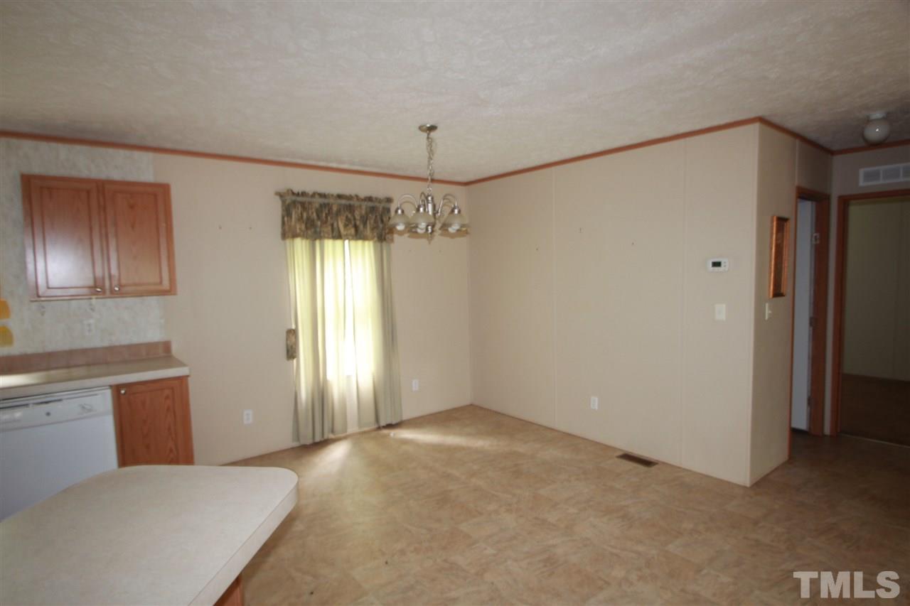 11973 Virgilina Road Roxboro, NC 27574 - Photo 4 of 10 a view of a big room with windows and cabinet