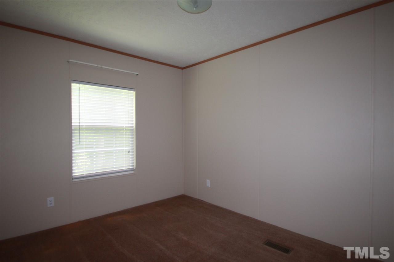 11973 Virgilina Road Roxboro, NC 27574 - Photo 8 of 10 an empty room with a window