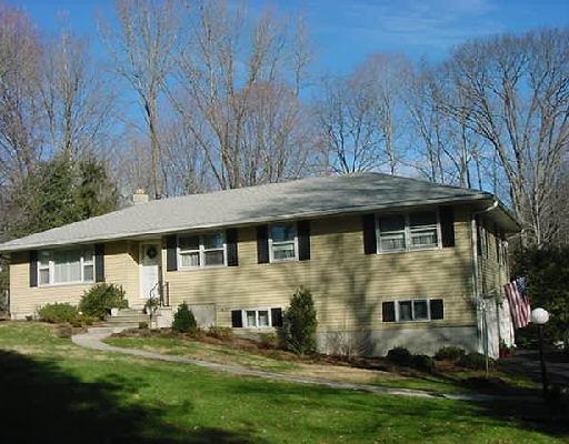 105 Plumtrees Road Bethel, CT 06801 - Photo 1 of 1 a front view of a house with a yard table and chairs
