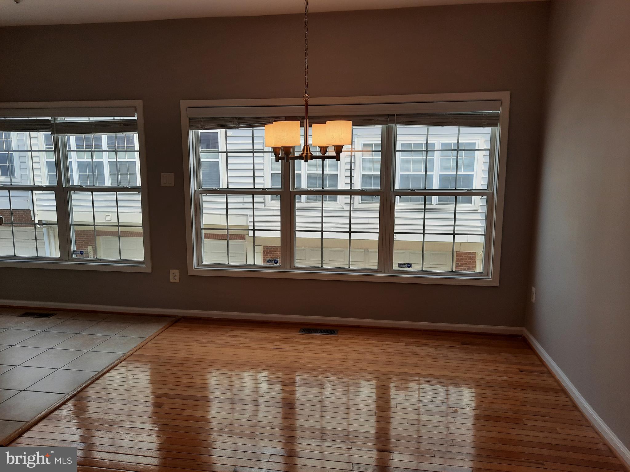 10258 Rutland Round Road, Unit 13 Columbia, MD 21044 - Photo 11 of 46 a view of empty room with wooden floor and fan