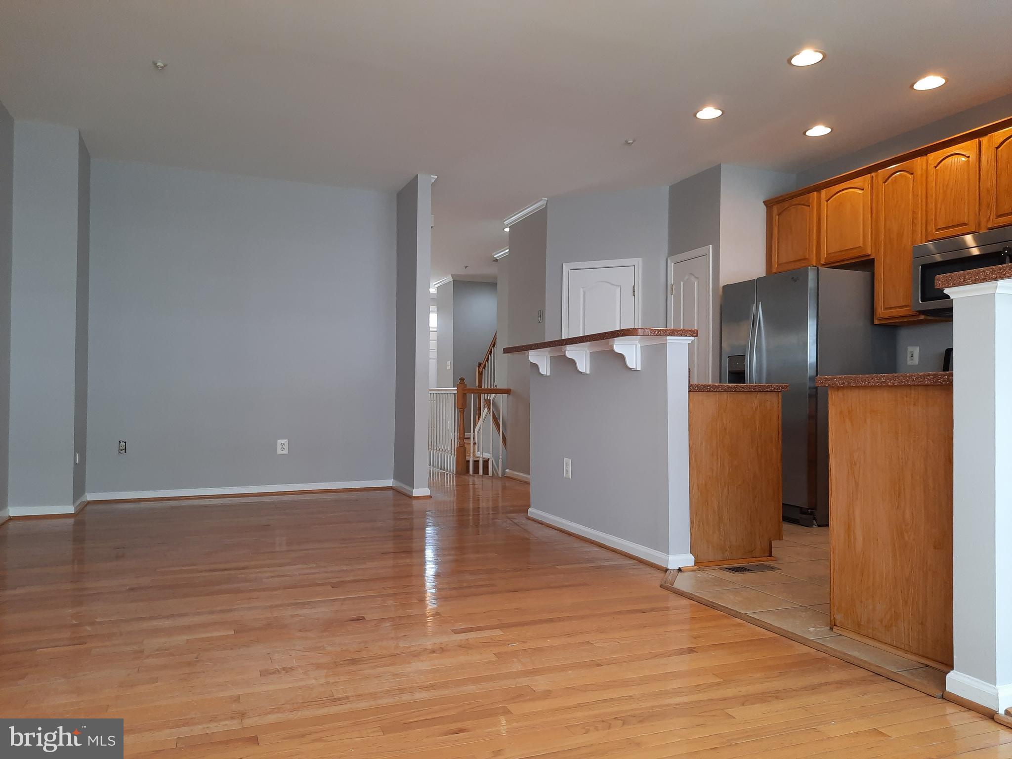 10258 Rutland Round Road, Unit 13 Columbia, MD 21044 - Photo 15 of 46 a view of a refrigerator in kitchen and wooden floor