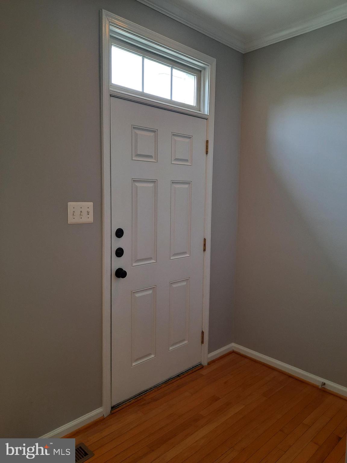 10258 Rutland Round Road, Unit 13 Columbia, MD 21044 - Photo 2 of 46 an empty room with wooden floor and windows
