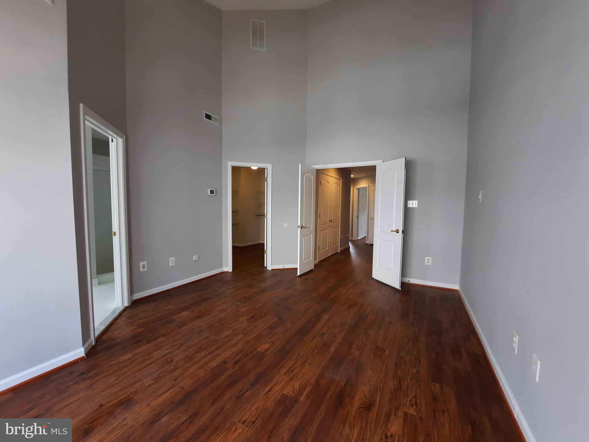 10258 Rutland Round Road, Unit 13 Columbia, MD 21044 - Photo 21 of 46 a view of an empty room with wooden floor and closet