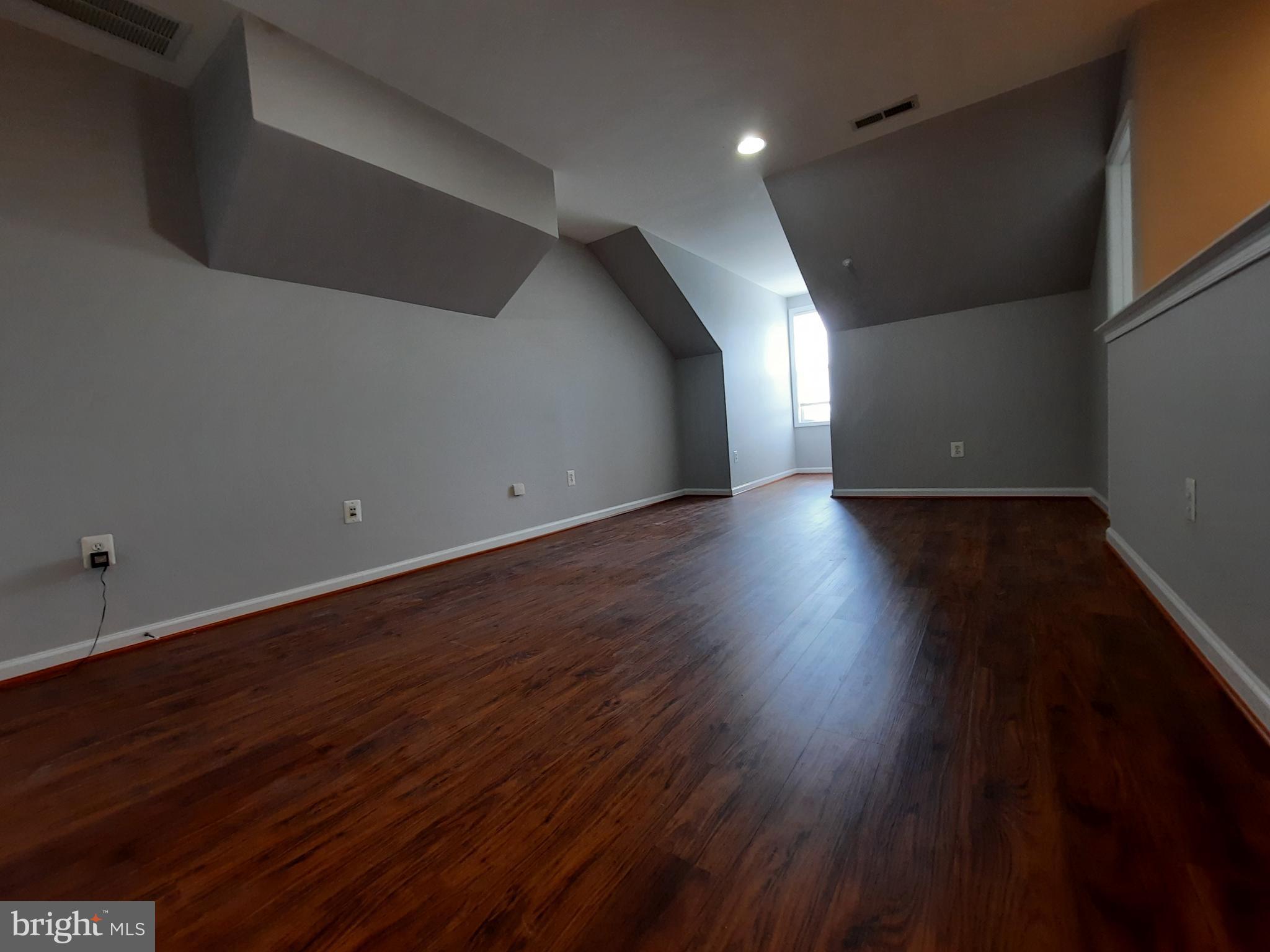 10258 Rutland Round Road, Unit 13 Columbia, MD 21044 - Photo 31 of 46 a view of an empty room with wooden floor