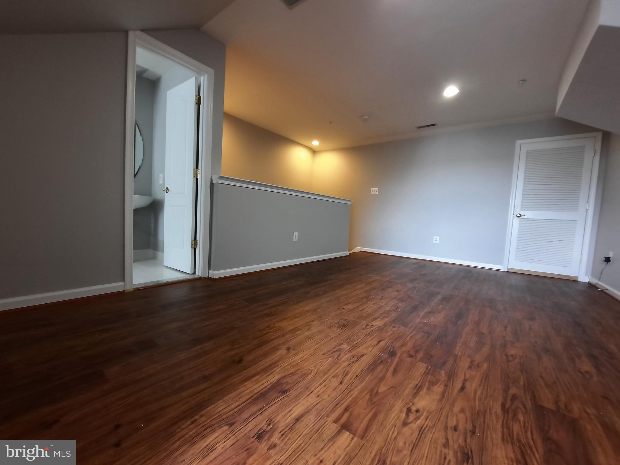 10258 Rutland Round Road, Unit 13 Columbia, MD 21044 - Photo 32 of 46 a view of an empty room with wooden floor and closet