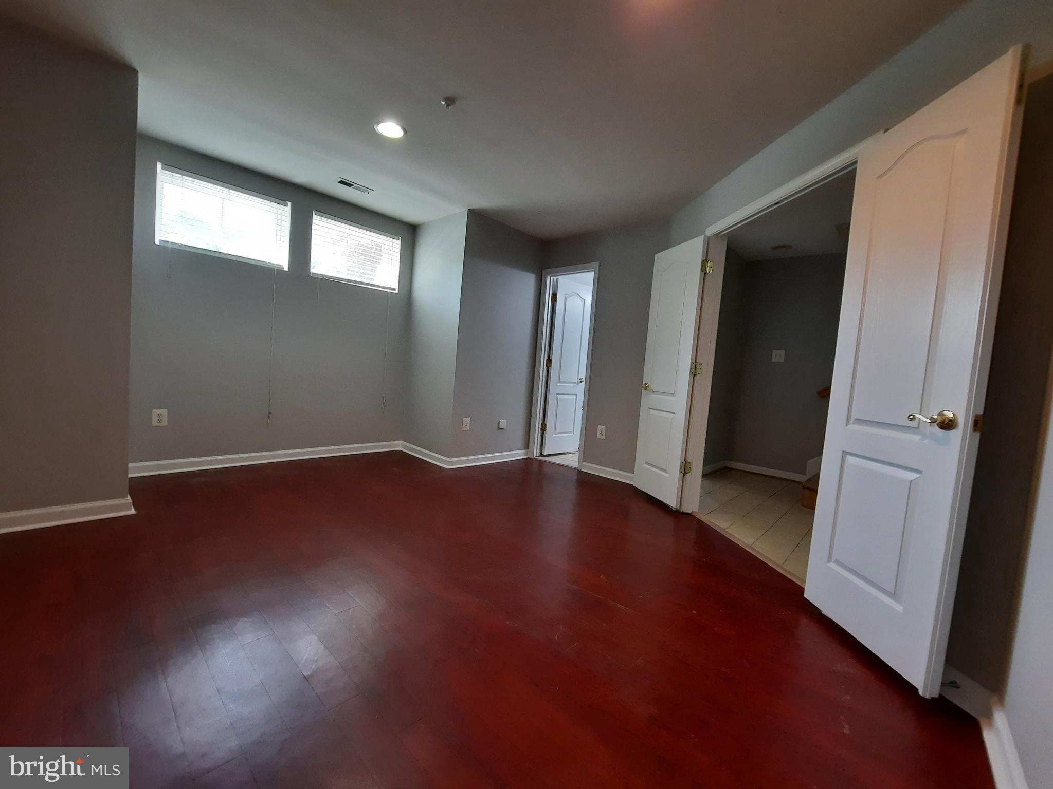10258 Rutland Round Road, Unit 13 Columbia, MD 21044 - Photo 36 of 46 an empty room with wooden floor and windows