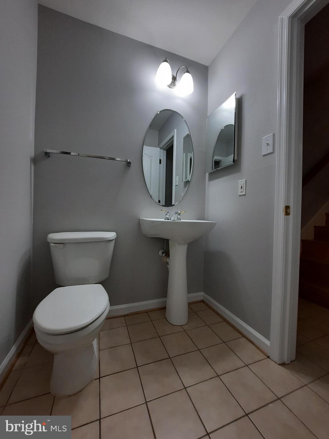 10258 Rutland Round Road, Unit 13 Columbia, MD 21044 - Photo 37 of 46 a bathroom with a toilet a sink and mirror