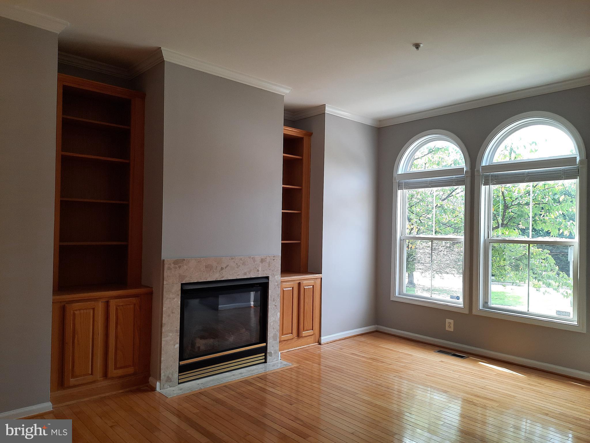 10258 Rutland Round Road, Unit 13 Columbia, MD 21044 - Photo 5 of 46 an empty room with windows and fireplace