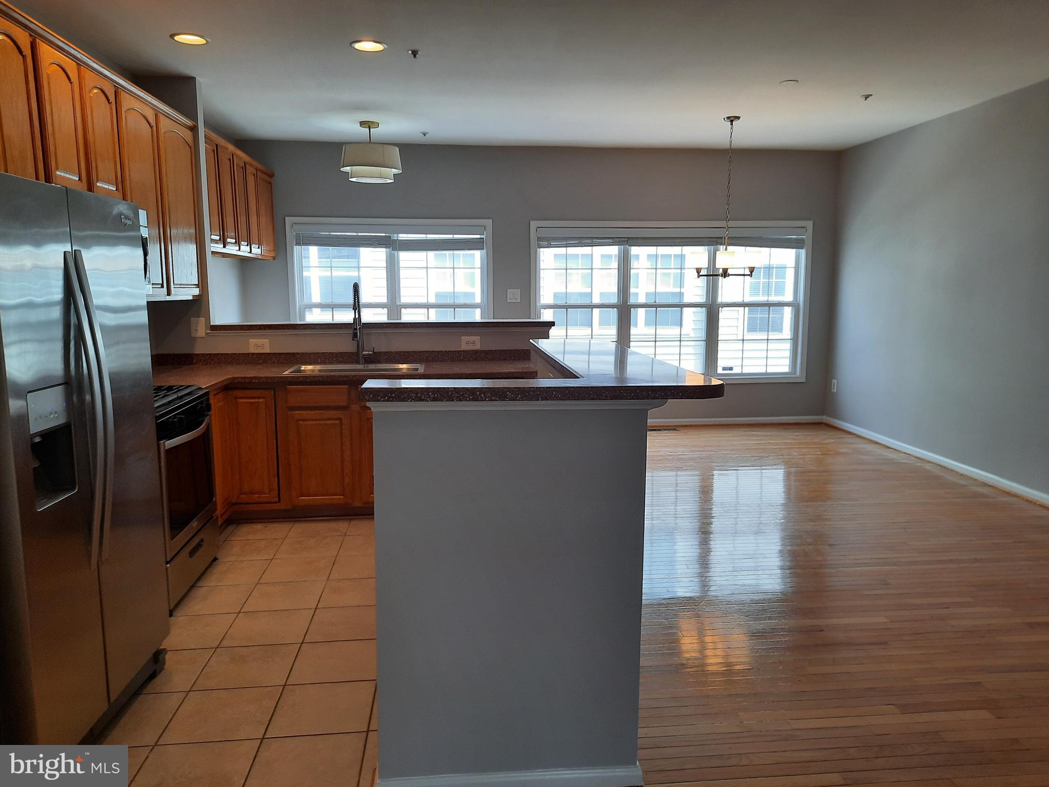 10258 Rutland Round Road, Unit 13 Columbia, MD 21044 - Photo 7 of 46 a kitchen with stainless steel appliances granite countertop a stove a sink and a refrigerator