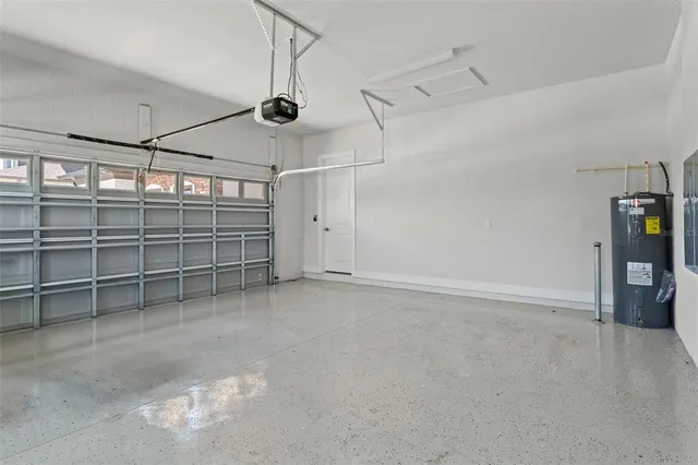 a living room with furniture and a view of kitchen