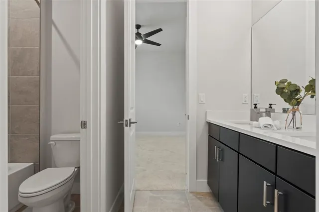 a large kitchen with cabinets chairs and refrigerator