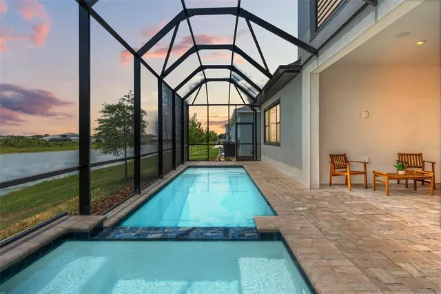 a living room with furniture a dining table and a chandelier