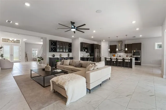 a bathroom with a tub a sink double vanity and mirror