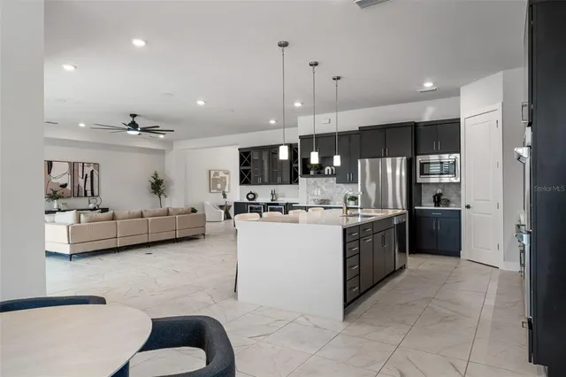 a view of an empty room with a ceiling fan and window