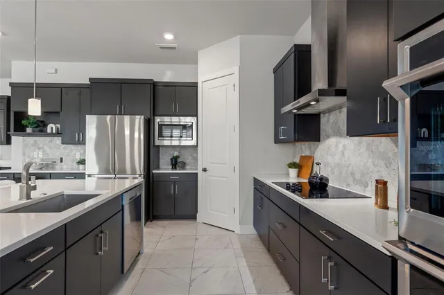 a bedroom with a bed and a flat tv screen on the dresser