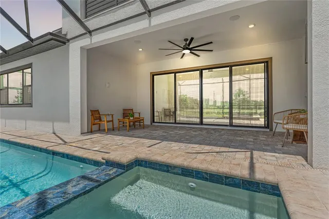a living room with furniture a chandelier and a window