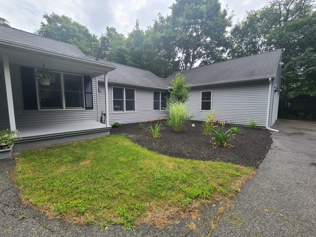 123 Boston Road Palmer, MA 01069 - Photo 3 of 33 a front view of a house with a garden and plants
