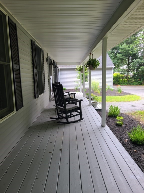 123 Boston Road Palmer, MA 01069 - Photo 4 of 33 a view of a patio with table and chairs and wooden floor