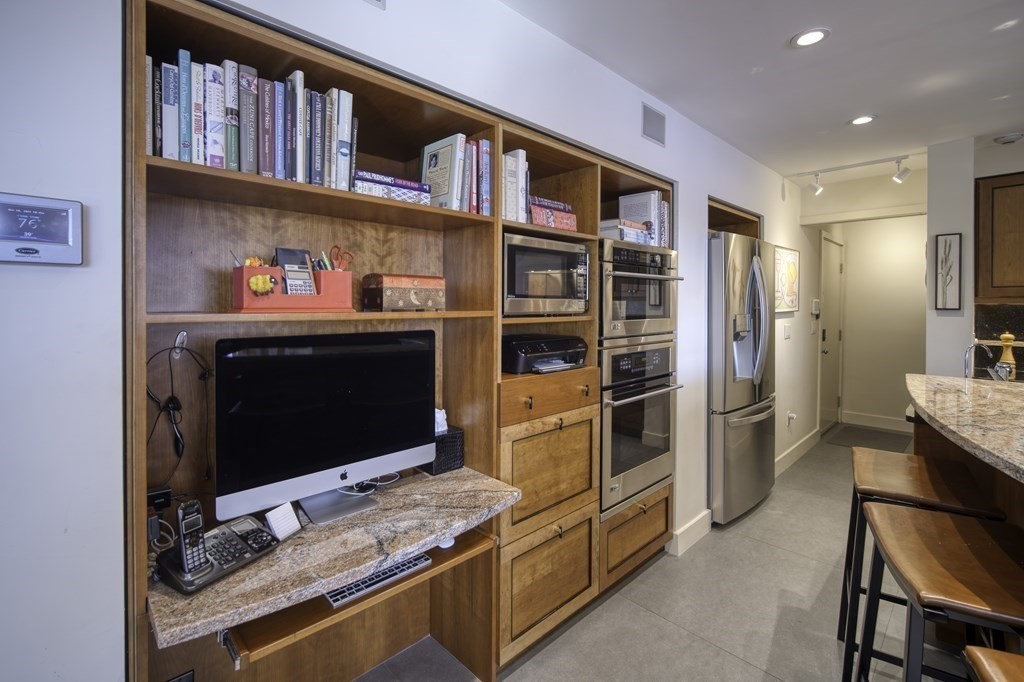 37 Beverly Road Arlington, MA 02474 - Photo 13 of 42 a kitchen with stainless steel appliances kitchen island granite countertop a refrigerator and a stove top oven