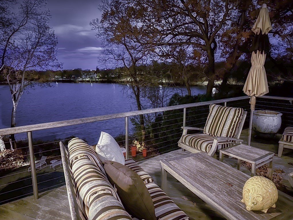 37 Beverly Road Arlington, MA 02474 - Photo 18 of 42 a roof deck with couches and wooden fence
